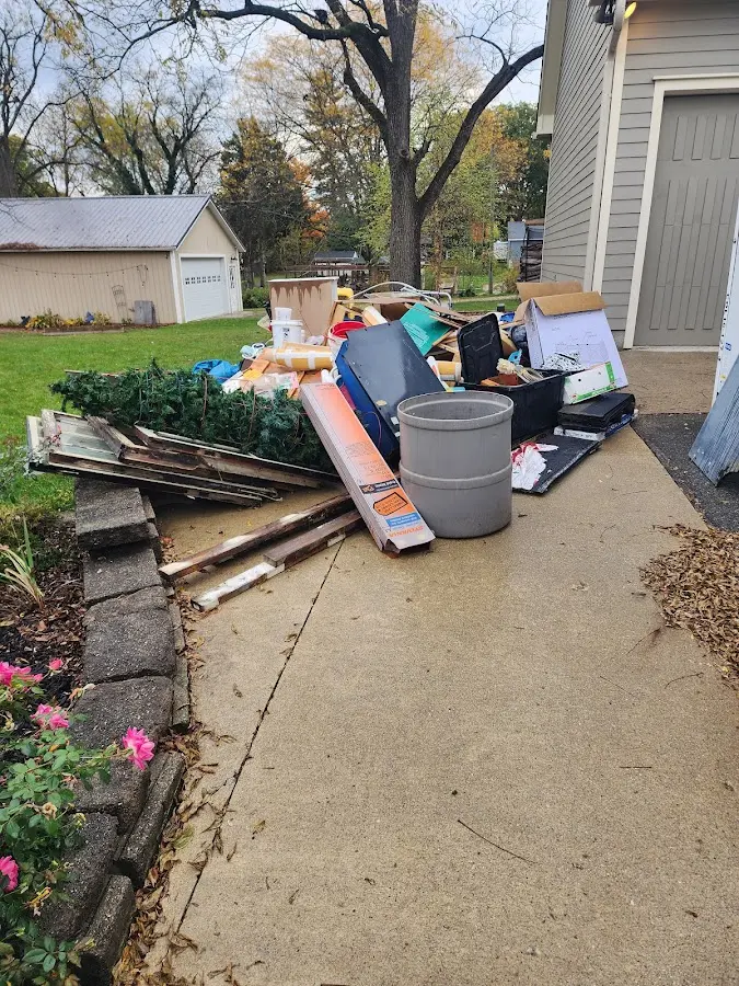 Dumpster being loaded with debris for Estate Cleanout Dumpster Rental in Woods Cross
